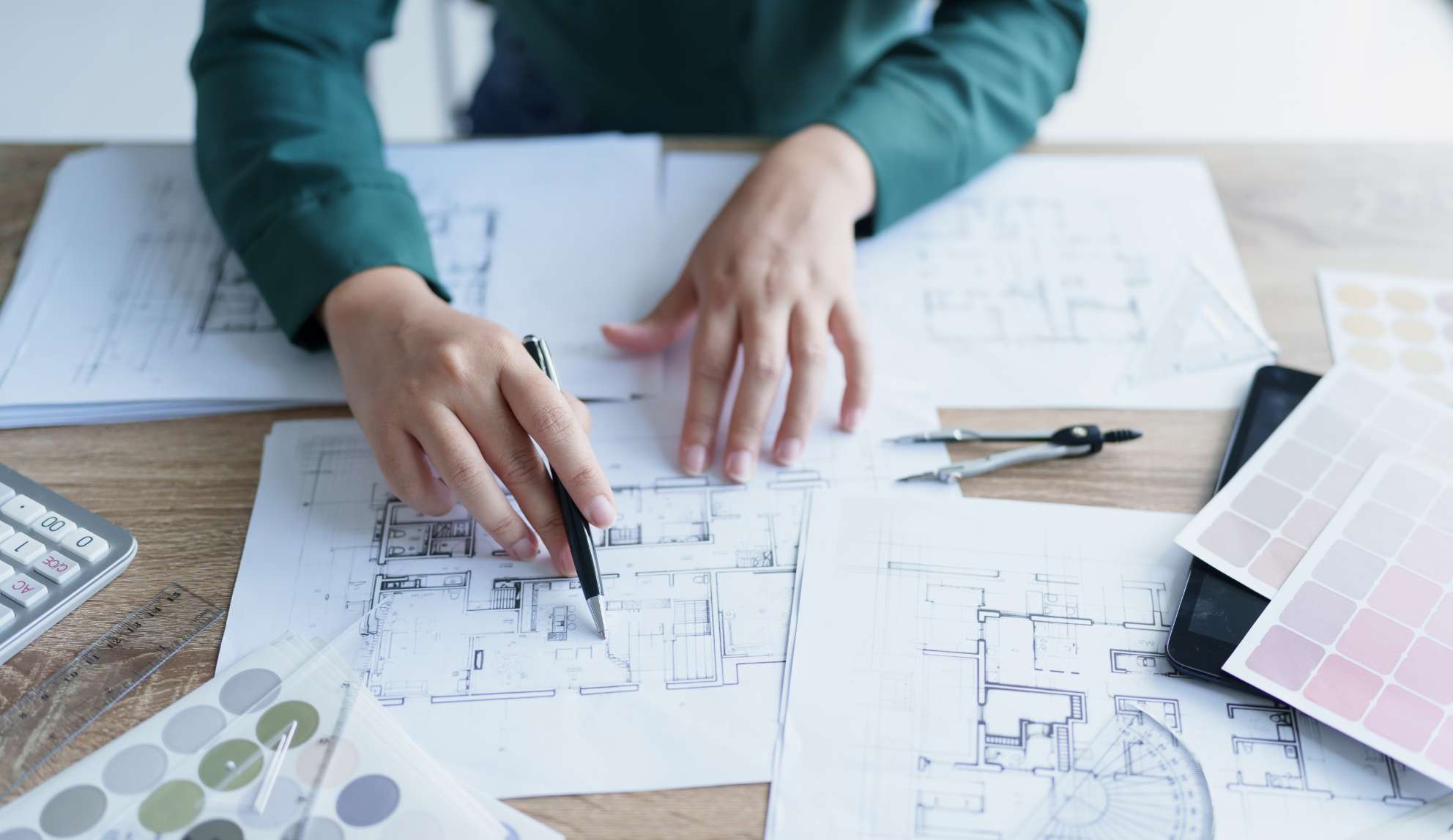 Man working over blueprints of a new build